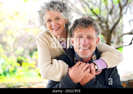 Alternde Liebesvögel. Porträt eines glücklichen, verheirateten Seniorenpaares, das sich draußen anfreundet. Stockfoto