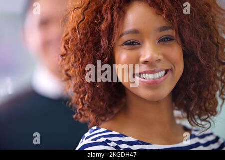 Lächeln Formular 9-5. Nahaufnahmen einer jungen afroamerikanischen Geschäftsfrau, die selbstbewusst in die Kamera lächelt. Stockfoto