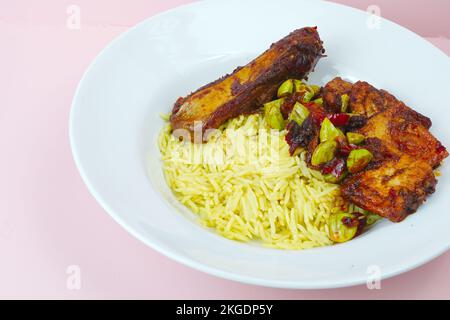 Geräucherter Stachelrochen mit Chilisauce, Stinkbohnen mit Basmati-Reis Stockfoto