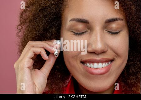 Nahaufnahme einer jungen Frau mit kabellosen Kopfhörern Stockfoto