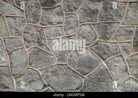 Graue rustikale Steinmauer. Stockfoto
