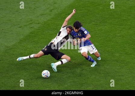 Thomas Muller aus Deutschland (links) und Takefusa Kubo aus Japan kämpfen während des Spiels der Gruppe E der FIFA-Weltmeisterschaft im internationalen Stadion von Khalifa in Doha, Katar, um den Ball. Bilddatum: Mittwoch, 23. November 2022. Stockfoto