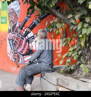 Neu-Delhi, Indien - 25. Dezember 2021 - Alter armer Mann, der während der Wintersaison in der Altstadt von Delhi Tee trinkt, Delhi Street Photography Stockfoto