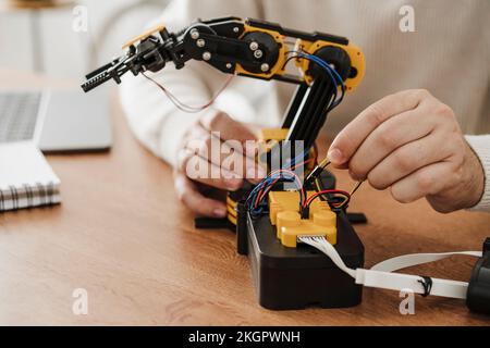 Ingenieur, der am Roboterarm am Schreibtisch im Büro arbeitet Stockfoto