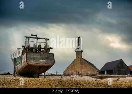 Frankreich, Bretagne, Camaret-sur-Mer, Trawler auf dem Schiffsfriedhof mit Chapelle Notre-Dame-De-Rocamadour im Hintergrund Stockfoto