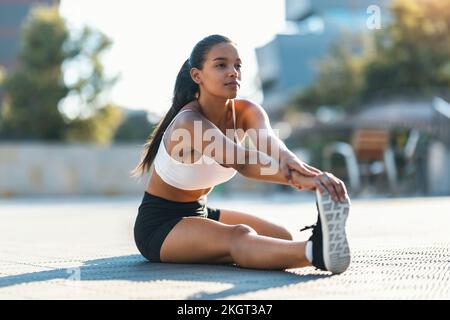 Teenager-Mädchen, die an sonnigen Tagen Stretching-Übungen macht Stockfoto