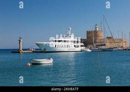 Fort St. Nikolaus plus große private Yacht im Jachthafen Mandraki, Rhodos, Griechenland. Stockfoto