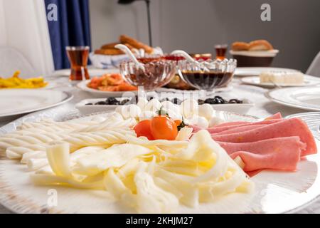 Selektiver Fokus und Nahaufnahme der Käseplatte. Köstliches, reichhaltiges, traditionell hausgemachtes türkisches Frühstück. Stockfoto