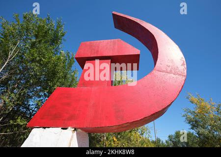 Ein riesiger roter Hammer und eine Sichel, Skulptur aus Sowjetunion, Russland, kommunistischen Symbolen, Statue, Denkmal. Im Museum für die Opfer der politischen Unterdrückung in Stockfoto