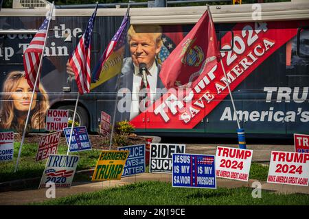 Viele amerikanische Flaggen und Schilder vor einem Wahlbus mit Bildern von Trump und Melania Stockfoto