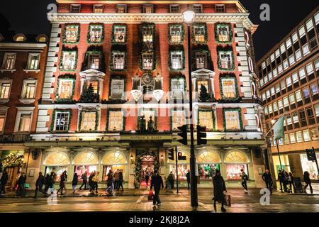 London, Großbritannien. 24.. November 2022. Der Großteil des Kaufhauses Fortnum & Mason ist wie ein riesiger Adventskalender dekoriert, wobei das Jahr 2022 an der Ecke zu sehen ist. Menschen in der Bond Street, Mayfair's berühmter Einkaufsstraße, und entlang Piccadilly stöbern durch die Schaufenster und bewundern die vielen bunten Ausstellungen und aufwändigen Weihnachtsdekorationen in den Luxusgeschäften von Mayfair. Kredit: Imageplotter/Alamy Live News Stockfoto