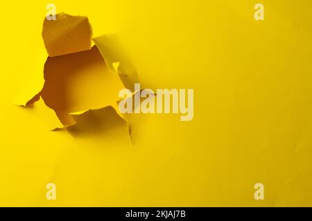 Zerrissenes gelbes Papier mit Kopierbereich auf gelbem Hintergrund Stockfoto