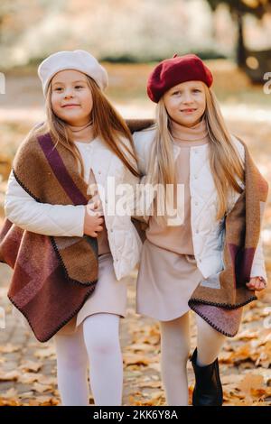 Glückliche Kinder kuscheln in einem schönen Herbstpark Stockfoto