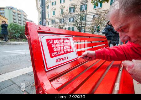 25/11/2022 Rom: Am Internationalen Tag zur Beseitigung der Gewalt gegen Frauen, Filcams, Flai, FLC und FP Cgil in Verbindung mit dem römischen Stadtbezirk XII in Largo Bernardino da Feltre in Trastevere eine Stadtbank rot gemalt, Und legte eine Gedenkplakette zur Erinnerung an die kostenlose Nummer 1522 auf, um Fälle von Missbrauch oder Gewalt zu melden. PS: Das Foto kann unter Berücksichtigung des Kontextes, in dem es aufgenommen wurde, und ohne diffamierende Absicht des Anstands der repräsentierten Personen verwendet werden. Stockfoto