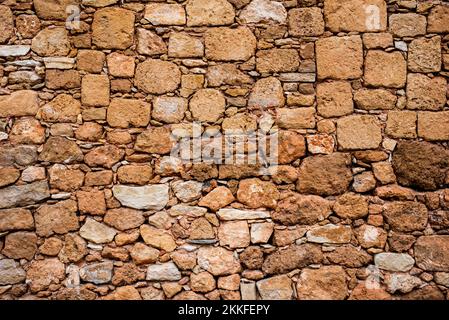 Hintergrund. Steinmauer. Gelbe Ziegel. Gelbe Steinmauer. Muster. Stockfoto