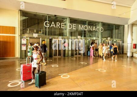 Touristen,mit,Koffern,am,Bahnhof Monaco,Gare de Monaco,Monte Carlo,Monaco,Südfrankreich,Frankreich,Frankreich,Europa,europäisch,August,Sommer.Mittelmeer,Küste,Stadt,Staat,Land,reich,Millionäre,Millionäre,superreich,Mega reich, Stockfoto
