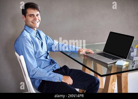 Hier wird die harte Arbeit erledigt. Porträt eines jungen Geschäftsmannes, der an seinem Schreibtisch sitzt. Stockfoto