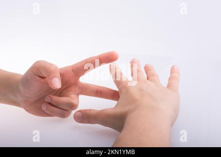 Hände zeigen die Symbole Schere Stein Papier Stockfoto