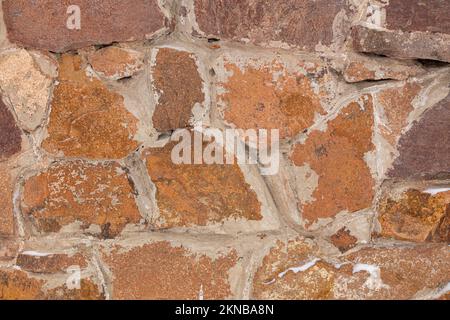 Textur einer Steinmauer. Alte Burg Stein Wand Textur Hintergrund. Stein Wand als Hintergrund oder Textur. Teil einer Mauer aus Stein, für den Hintergrund oder Text Stockfoto