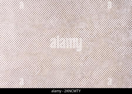 Texturhintergrund aus Velours beigefarbenem Stoff mit Punktmuster. Stoffstruktur aus Polstermöbeln, Textilmaterial, Innendesign, Wanddekor. Fa Stockfoto