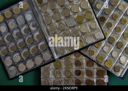 Сoins aus verschiedenen Ländern sind in durchsichtigen Blisterpackungen angeordnet. Seite aus Album voll mit alten Münzen. Münzlagermethode. Numismatische Sammlung. Bis Stockfoto