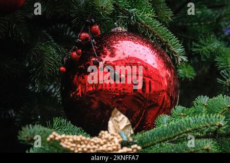 London, Großbritannien. 27.. November 2022. Das Außenministerium spiegelt sich in einer Kugel wider. Der Downing Street Christmas Tree ist mit bunten Baumbällen dekoriert und verleiht der ansonsten grauen Straße trotz des schlechten Wetters einen festlichen Touch. Kredit: Imageplotter/Alamy Live News Stockfoto