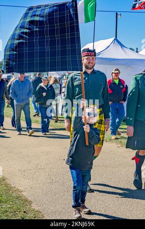 Während der Parade der Clan-Tartane bei den Scottish Highland Games am 13. November 2022 in Gulfport, Mississippi, tragen die Menschen Tartanbanner. Stockfoto