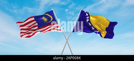 Zwei gekreuzte Flaggen Bosnien und Herzegowina und Malaysia, die im Wind am bewölkten Himmel winken. Beziehungskonzept, Dialog, Reisen zwischen zwei Ländern. Stockfoto