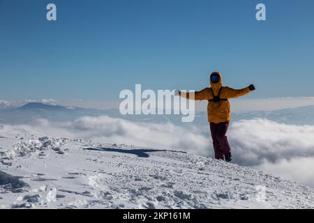 Ein glücklicher Wanderer genießt den Blick auf die Klippen des Winterbergs, ein Adrenalinabenteuer im Freien Stockfoto