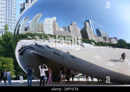 Chicago, USA - August 2022: Die Skulptur Cloud Gate (Bean) im Millennium Park zieht Besucher an, um die geschwungenen Reflexionen ihrer selbst zu bewundern Stockfoto