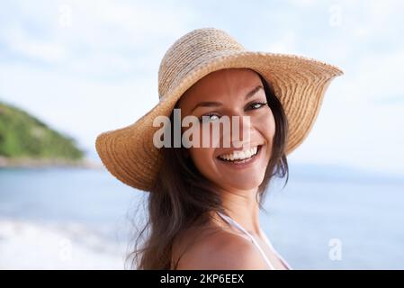 Sommerurlaub in der Luft. Abgeschnittenes Porträt einer schönen jungen Frau am Strand. Stockfoto