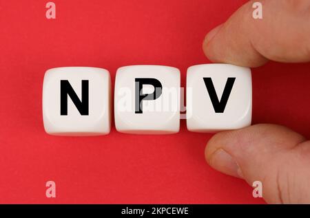 Business and finance. On the red surface, white cubes with the inscription - NPV Stockfoto