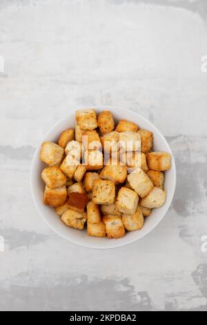 Knusprige, trockene Würfel Weißbrot in einer weißen Schüssel Stockfoto