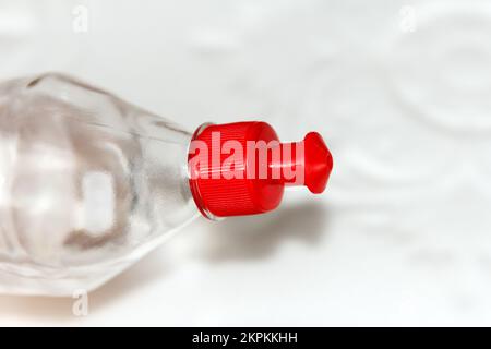 Flasche mit rotem Deckel mit vielseitigem, transparentem Acrylkleber für Reparaturarbeiten, hält dem Hintergrund von gepressten Schaumplatten für cei stand Stockfoto