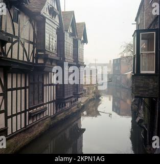 1980er, historisch, Canterbury, Kent, England, UK. Alte elisabethanische Gebäude mit Holzrahmen, neben dem Great Stour River im Zentrum der Stadt. Stockfoto