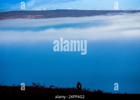 Ilkley, West Yorkshire, Großbritannien. 28.. November 2022. Wetter in Großbritannien. Nebel füllt das Tal unter den Rind- und Kalbfelsen auf dem berühmten Ilkley Moor bei Ilkley, West Yorkshire, Großbritannien. Die malerische Stadt Ilkley liegt im Wharfe Valley, am südlichen Ende der Yorkshire Dales. Die ehemalige Kurstadt wurde im 19. Jahrhundert berühmt, als Tausende wegen der frischen, belebenden Luft und erstklassigen Hotels zu Besuch kamen. Kredit: Windmill Images/Alamy Live News Stockfoto