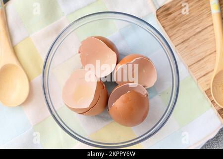 Eierschalen in einer weißen Schale auf dem Tisch Stockfoto