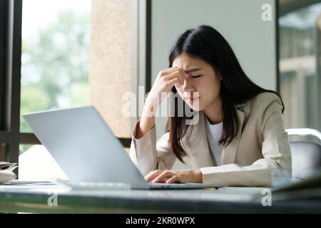 Gestresste Überarbeit Geschäftsfrau im Büro. Stockfoto