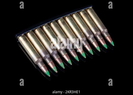 5,56mm Munition mit Patronen im Clip auf schwarzem Hintergrund Stockfoto