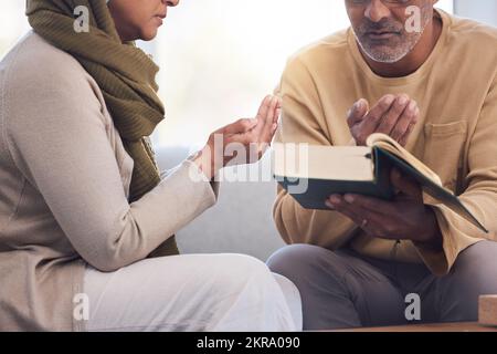 Gottesdienst, Gebete und muslimisches Paar mit einem koran, das spirituellen Glauben in ihrem Haus liest und studiert. Religion, Dankbarkeit und heiliger und islamischer Mann und Stockfoto