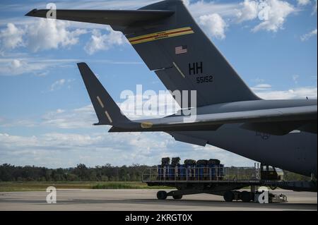 Soldaten der Royal Australian Army 176. Air Dispatch Squadron beladen Fracht in die USA Air Force C-17 Globemaster III während der Exercise Global Dexterity auf der RAAF Base Amberley, Queensland, 16. November 2022. Übung Global Dexterity 2022 wird auf der RAAF-Basis Amberley durchgeführt und soll dazu beitragen, die bilateralen taktischen Luftbrücke und Luftabwurfmöglichkeiten der United States Air Force (USAF) und der Royal Australian Air Force (RAAF) zu entwickeln. Sowohl die Vereinigten Staaten als auch Australien verlassen sich auf die C-17A, um mit ihrer Fähigkeit strategische und taktische Lufttransporte über die Indo-Pazifik-Region bereitzustellen Stockfoto