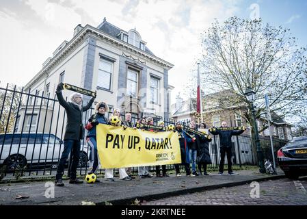 DEN HAAG - Mitglieder von Amnesty International, bevor sie der Botschaft von Katar Unterschriften anboten. Die Menschenrechtsorganisation fordert Katar und die FIFA auf, die betroffenen Wanderarbeitnehmer, die die Weltmeisterschaft ermöglicht haben, zu entschädigen. ANP BART MAAT niederlande out - belgien out Stockfoto