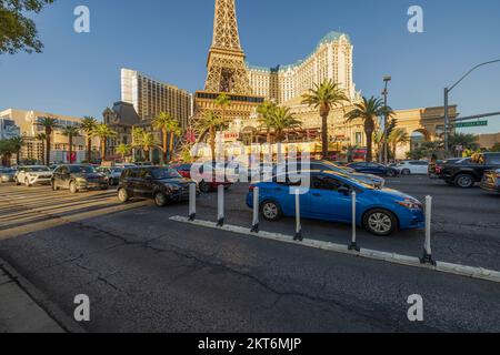 Wunderschöne Aussicht auf die Fahrzeuge im Verkehr auf dem Strip, die an wunderschönen Hotels auf blauem Himmel vorbeifahren. Las Vegas, Nevada, USA. Stockfoto