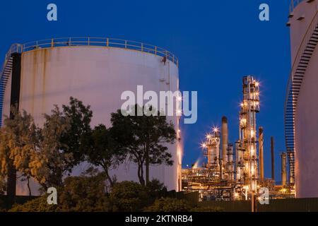 Lagertanks und Türme in der Öl- und Gasraffinerie in der Dämmerung. Stockfoto