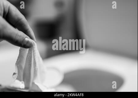 Einweg-Wischtücher werden auf der Toilette heruntergespült, wo sie Verstopfung und Probleme mit der Abwasserbehandlung verursachen können. Stockfoto