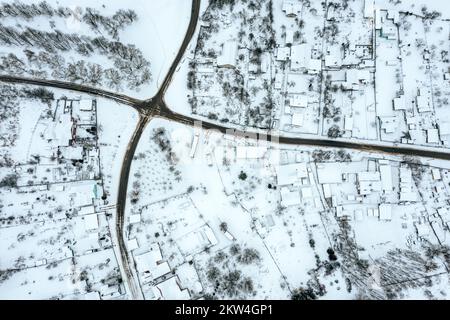 Luftdrohnenfoto mit Blick auf die Dächer des schneebedeckten Vorstadtviertels Stockfoto