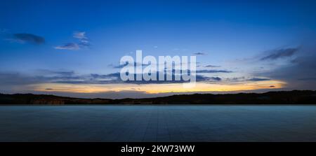 Leerer Fliesenboden mit dramatischem Himmel Stockfoto