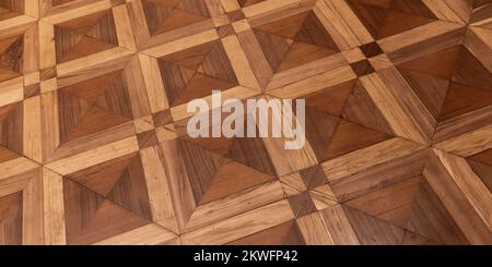 Altmodisches Parkett aus verschiedenen Holzarten Bretter mit geometrischem Muster. Hintergrundfoto Stockfoto