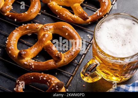 Frisch gebackene hausgemachte Brezeln und Bier vom Fass Stockfoto