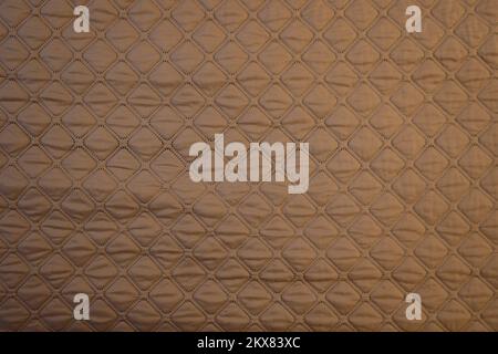 Gestrickter, brauner, brauner Hintergrund. Wunderschöne, olivbraune zinnbraune Stoffstruktur Stockfoto